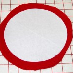 Freezer paper template pattern pressed onto the 2 layer fused red wool