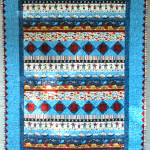 The 'striped' panel seemed to call for a quilt made in strips@ 